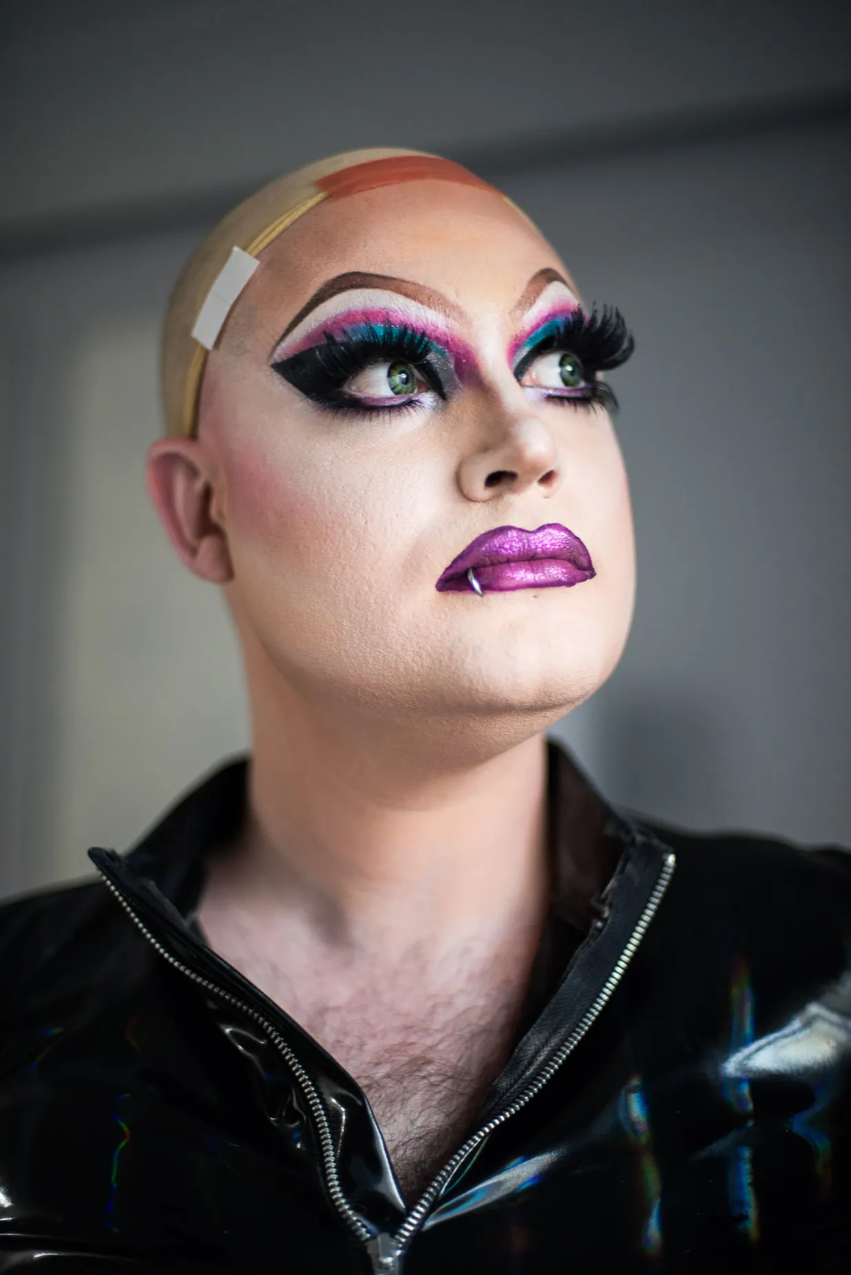 Soren poses thoughtfully before completing a drag costume and make up