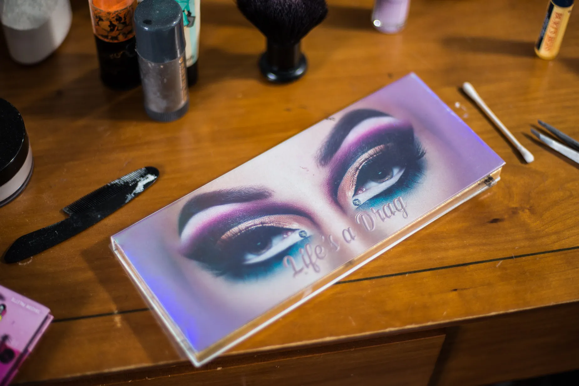 Soren's cosmetic bits and bobs on dressing table prior to drag performance at the After Dark night club in Reading England