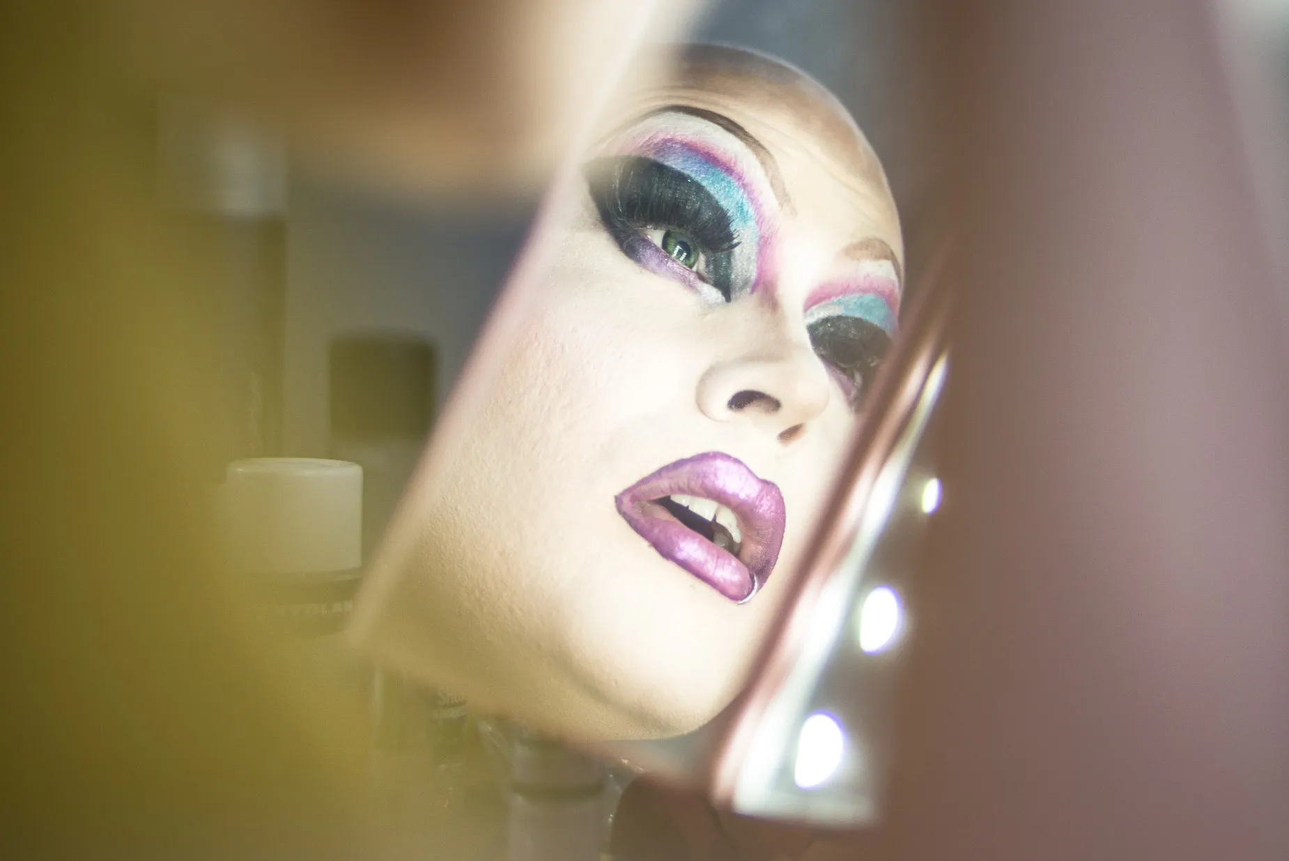 Soren reviewing make up in mirror, for a drag performance at the After Dark club in Reading England