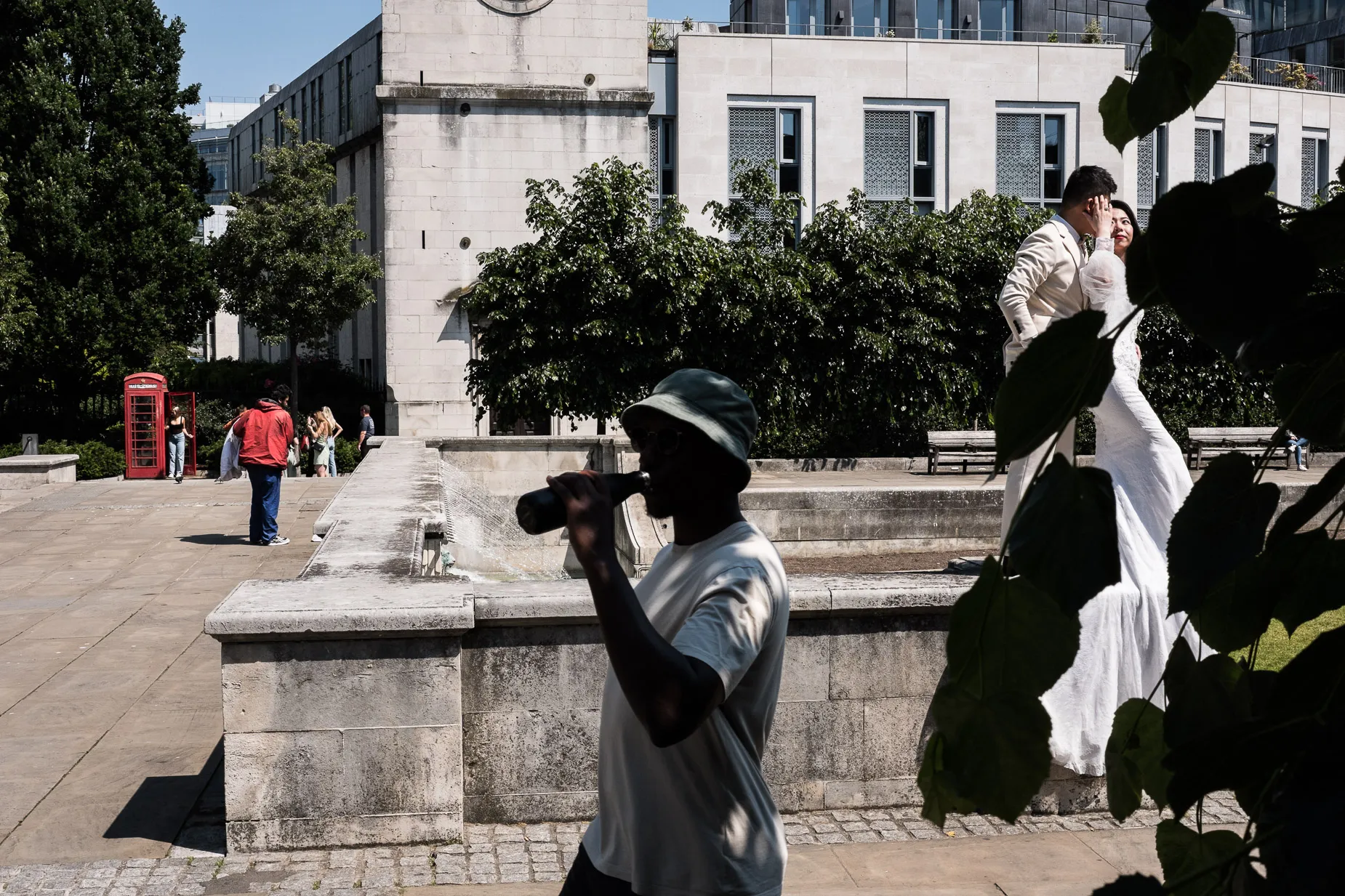 Street scene with, complex juxtapositions based around wedding scene, include a homeless man & man drinking