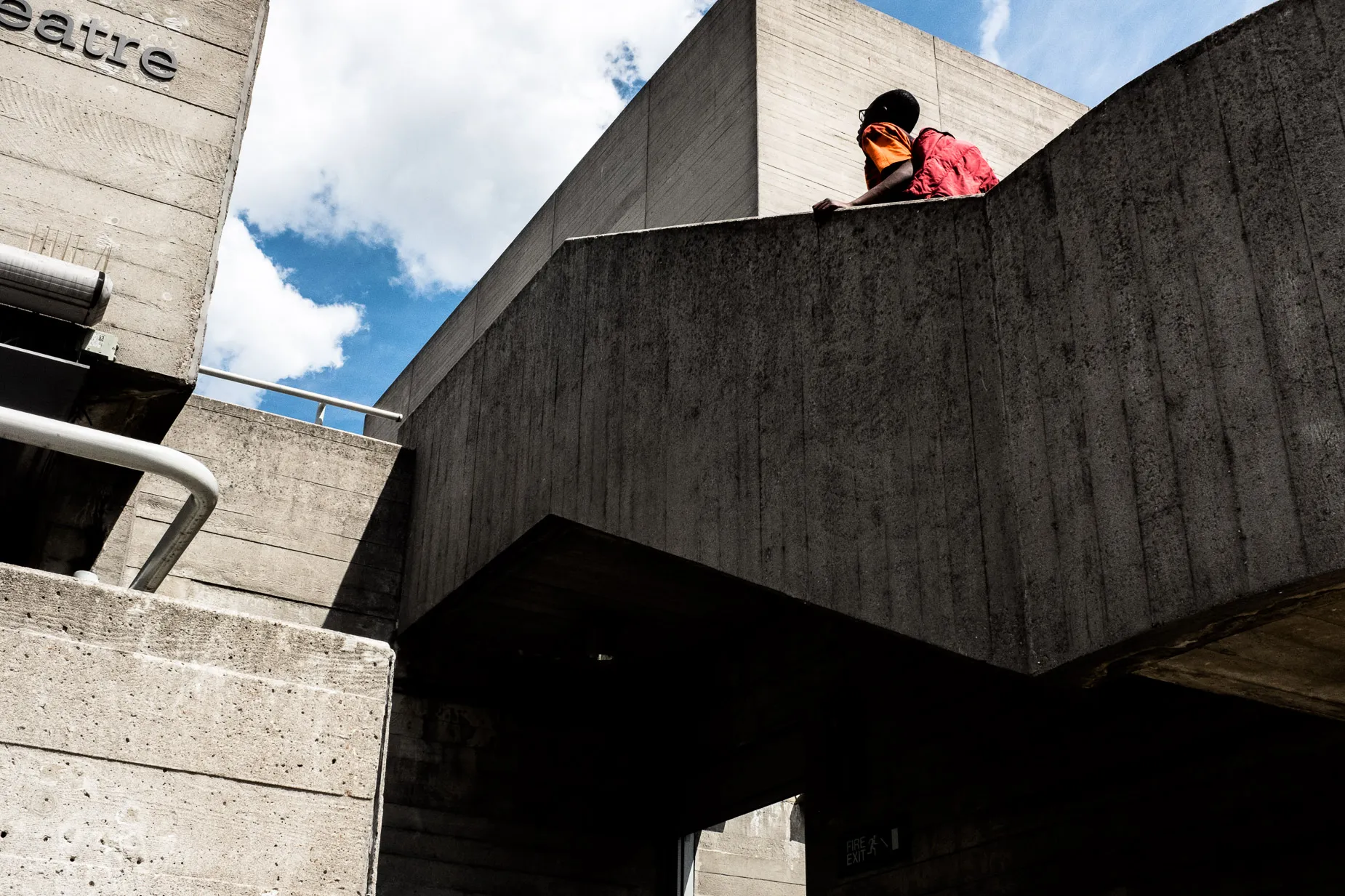 Abstractly framed Brutalist stone structure with man