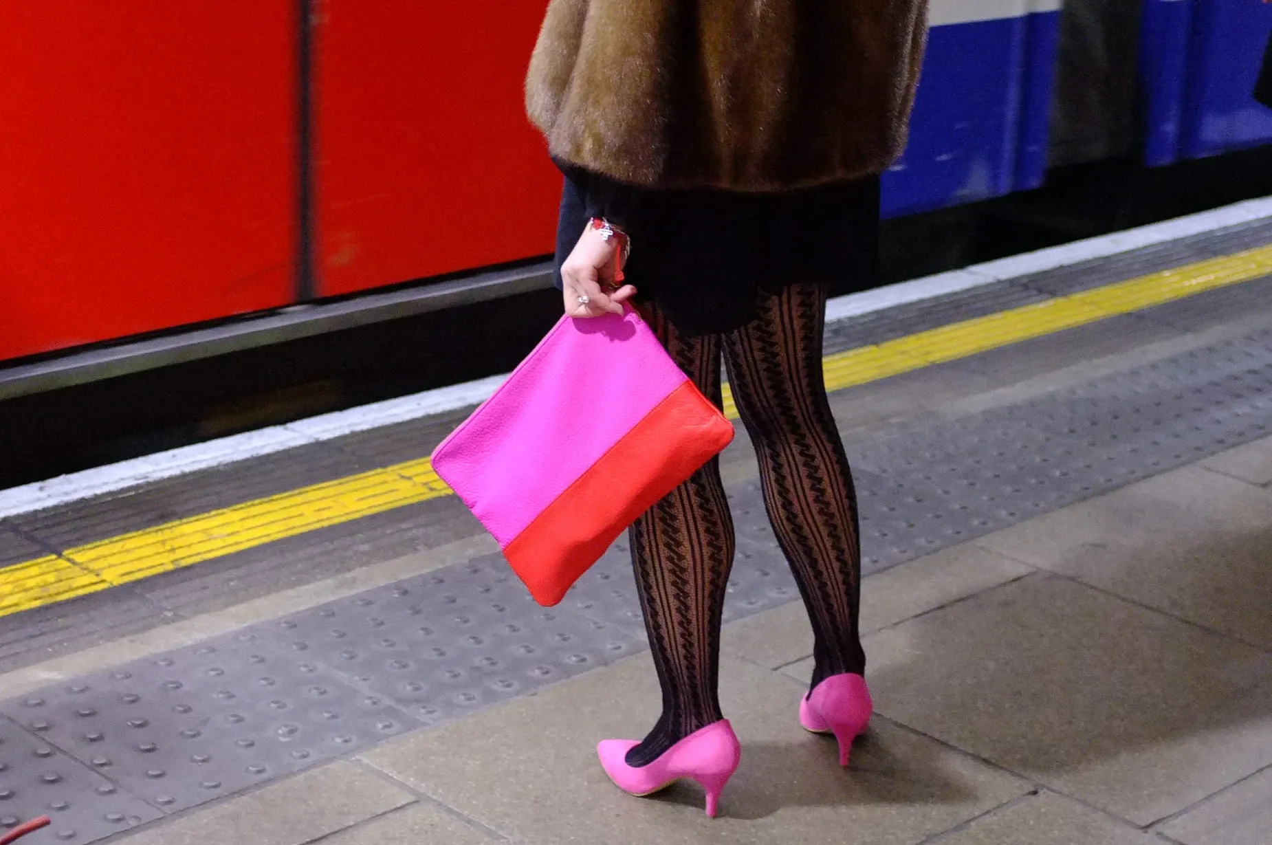 Woman stylishly holding pink purse with pink shoes by Street Photographer Darran K Roper