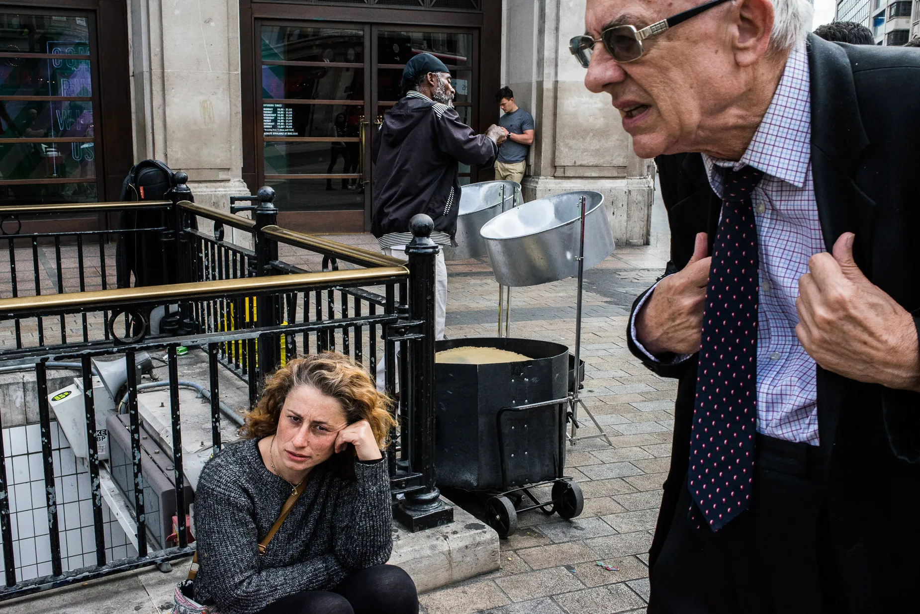 Slightly hunched elderly man holding the lapels of his jacket
