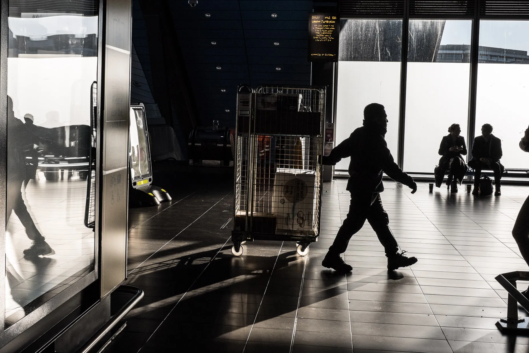 Three character silhouettes at train station