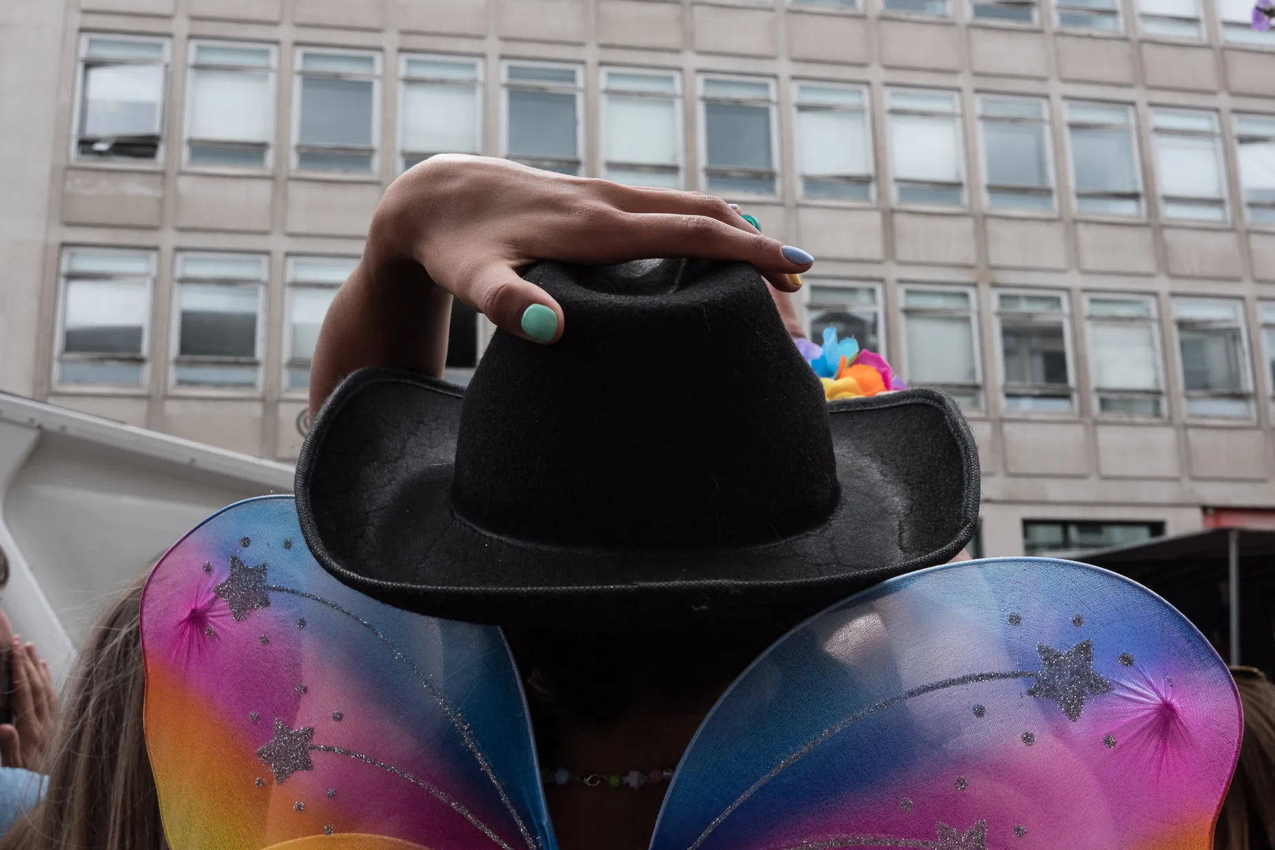 Strange hand on top cowboy hat