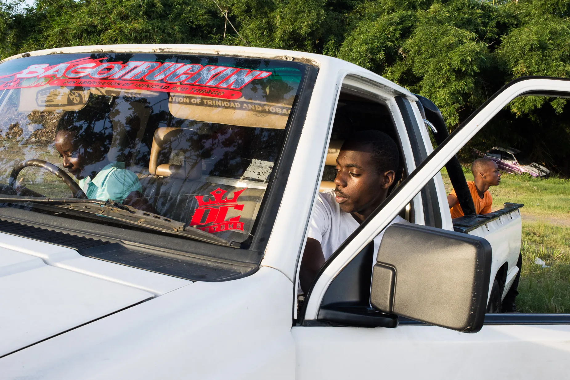 Teenagers in pick up truck at Dwight York Stadium. From the Tobago Street photography project by Darran K Roper
