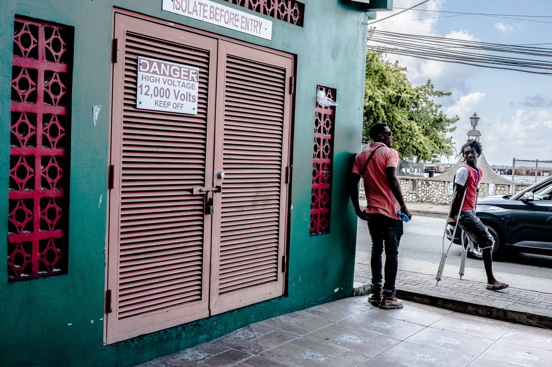 Amputee man with walking sticks greats man in down town Scarborough Tobago